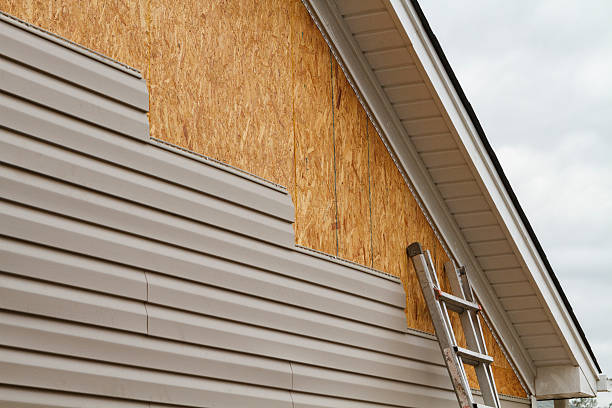 Professional Storm Damage Siding Repair technician working in Montgomery, IL